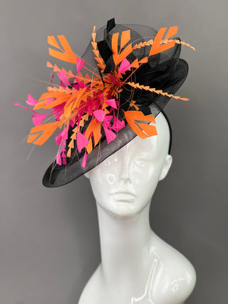 BLACK FASCINATOR WITH FUCHSIA AND ORANGE FEATHERS.