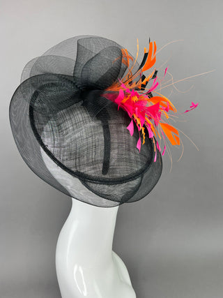 BLACK FASCINATOR WITH FUCHSIA AND ORANGE FEATHERS.