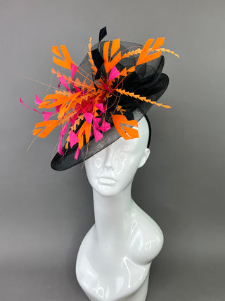 BLACK FASCINATOR WITH FUCHSIA AND ORANGE FEATHERS.