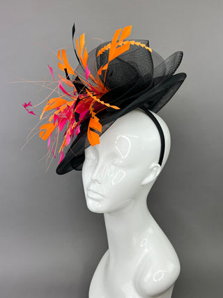 BLACK FASCINATOR WITH FUCHSIA AND ORANGE FEATHERS.