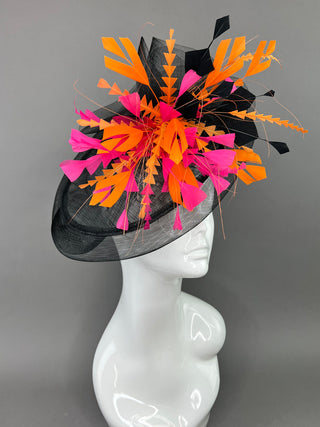 BLACK FASCINATOR WITH FUCHSIA AND ORANGE FEATHERS.