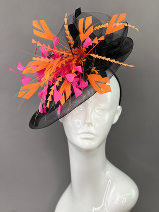 BLACK FASCINATOR WITH FUCHSIA AND ORANGE FEATHERS.