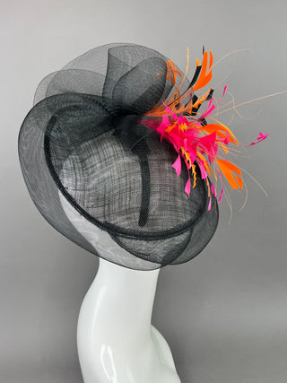 BLACK FASCINATOR WITH FUCHSIA AND ORANGE FEATHERS.