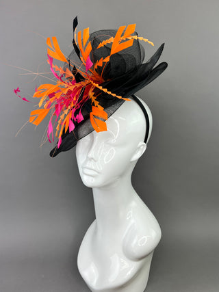 BLACK FASCINATOR WITH FUCHSIA AND ORANGE FEATHERS.