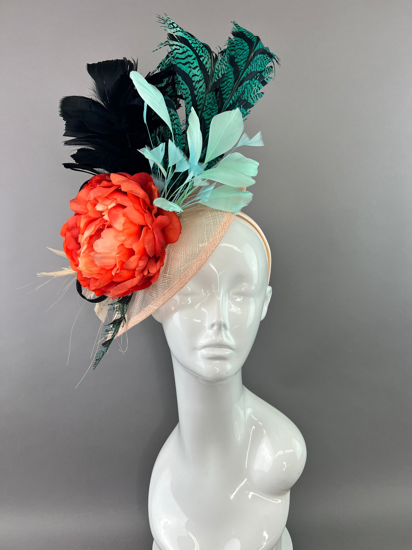 TEAL AND MINT FASCINATOR WITH ORANGE BLOOM