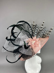 BLUSH PINK HAT WITH BLACK AND WHITE ACCENTS.