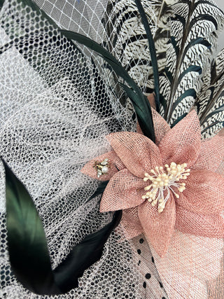 BLUSH PINK HAT WITH BLACK AND WHITE ACCENTS.