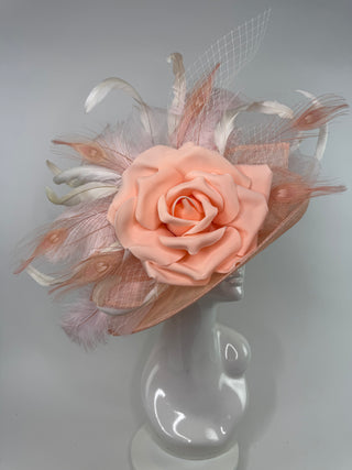 Side profile of the Bloom peach derby hat showing the elegant flipped-brim sinamay construction and delicate feather accents.