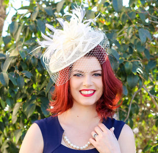 Ivory fascinator with veil and feathers on headband, ideal for weddings, races, and special occasions